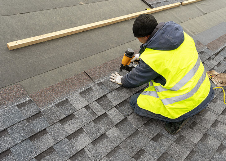 Roofing contractor working on a roof
